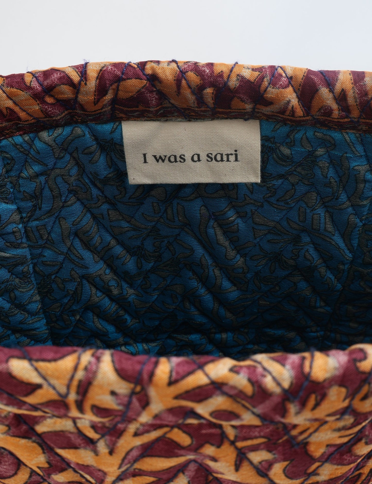 Elevate your style with our Quilted Tote Bag, a perfect fusion of fashion and sustainability. Made from vibrant upcycled saris, the newly quilted design adds strength and softness. With double fabric contrast straps and a unique sari lining, it's a statement of ethical elegance.