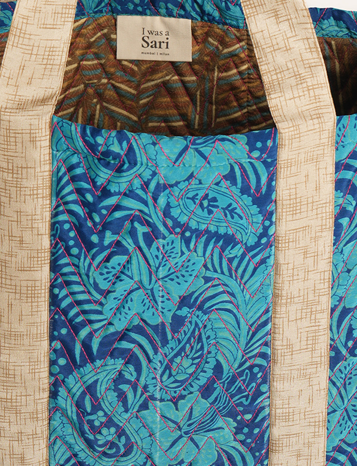 Elevate your style with our Quilted Tote Bag, a perfect fusion of fashion and sustainability. Made from vibrant upcycled saris, the newly quilted design adds strength and softness. With double fabric contrast straps and a unique sari lining, it's a statement of ethical elegance.