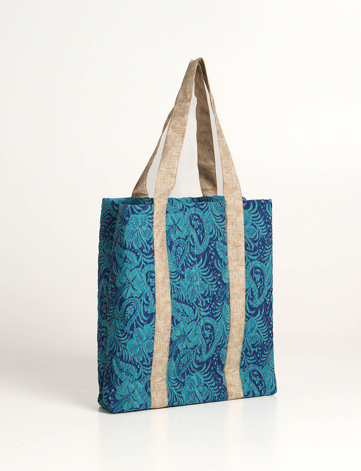 Elevate your style with our Quilted Tote Bag, a perfect fusion of fashion and sustainability. Made from vibrant upcycled saris, the newly quilted design adds strength and softness. With double fabric contrast straps and a unique sari lining, it's a statement of ethical elegance.