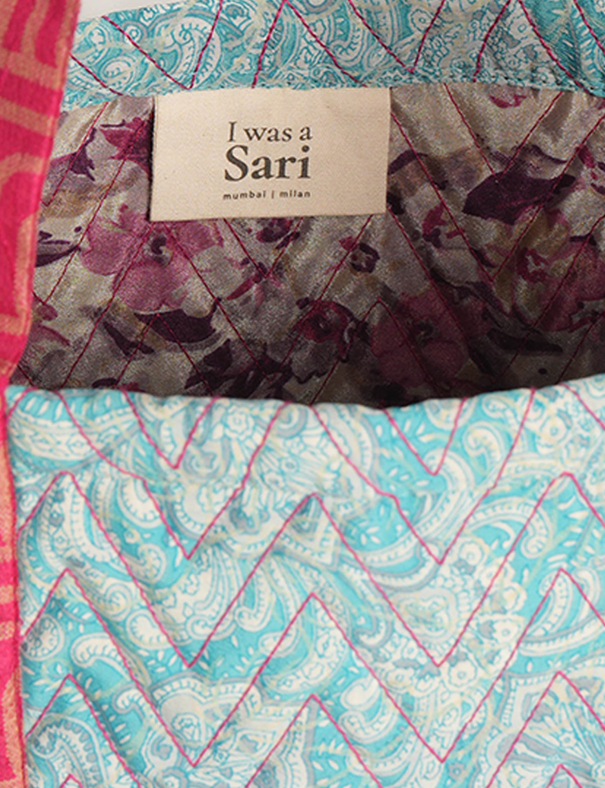 Quilted tote bag interior with floral and paisley patterns in blue, purple, and red, featuring "I was a Sari" label