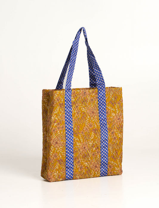 Elevate your style with our Quilted Tote Bag, a perfect fusion of fashion and sustainability. Made from vibrant upcycled saris, the newly quilted design adds strength and softness. With double fabric contrast straps and a unique sari lining, it's a statement of ethical elegance.