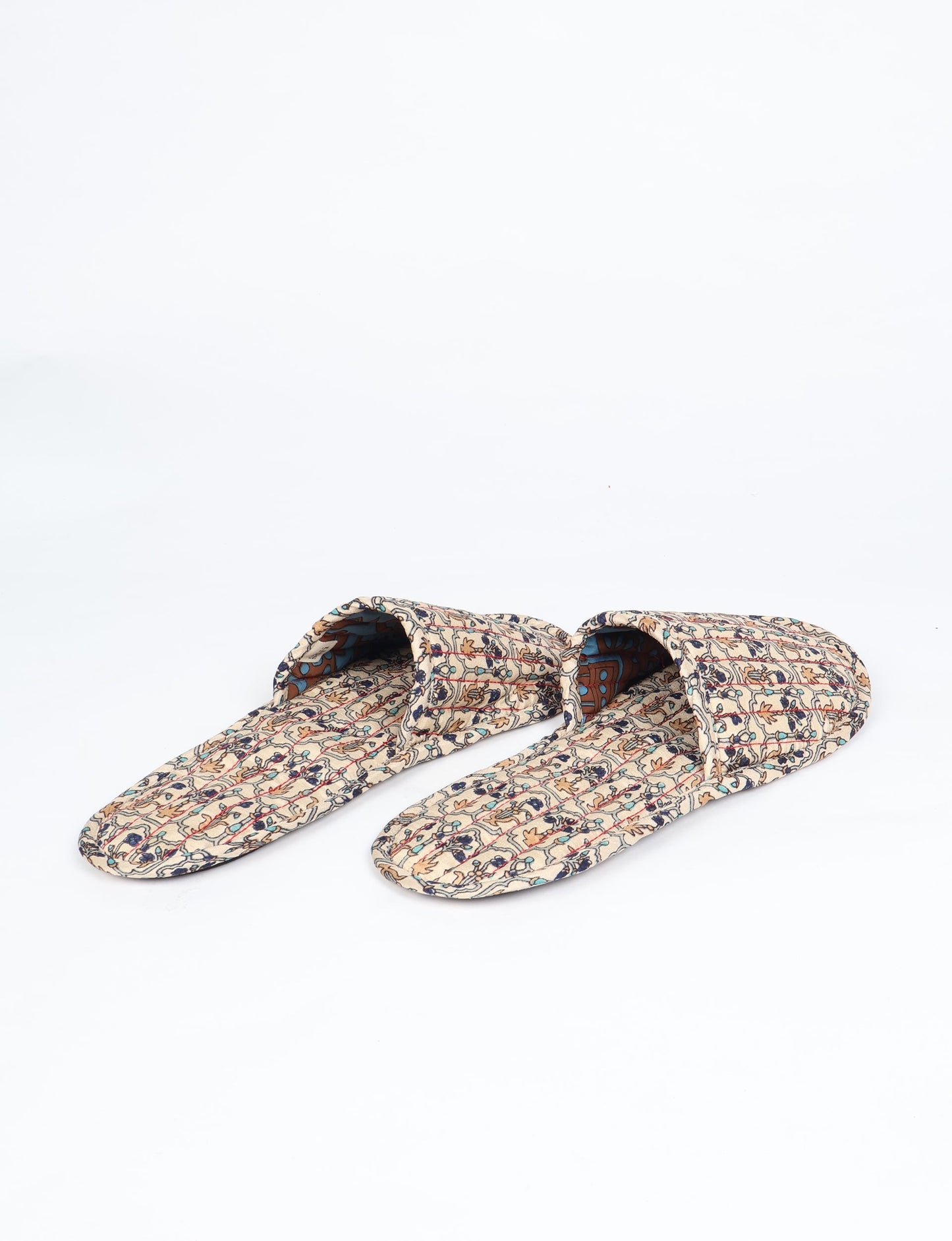 Elevate your downtime with our Quilted Slippers. Ethical, sustainable, and crafted by female artisans in Mumbai, these slippers offer cushioned comfort with a touch of chic style. Warm on the inside, fashionable on the outside, step into sustainable luxury.