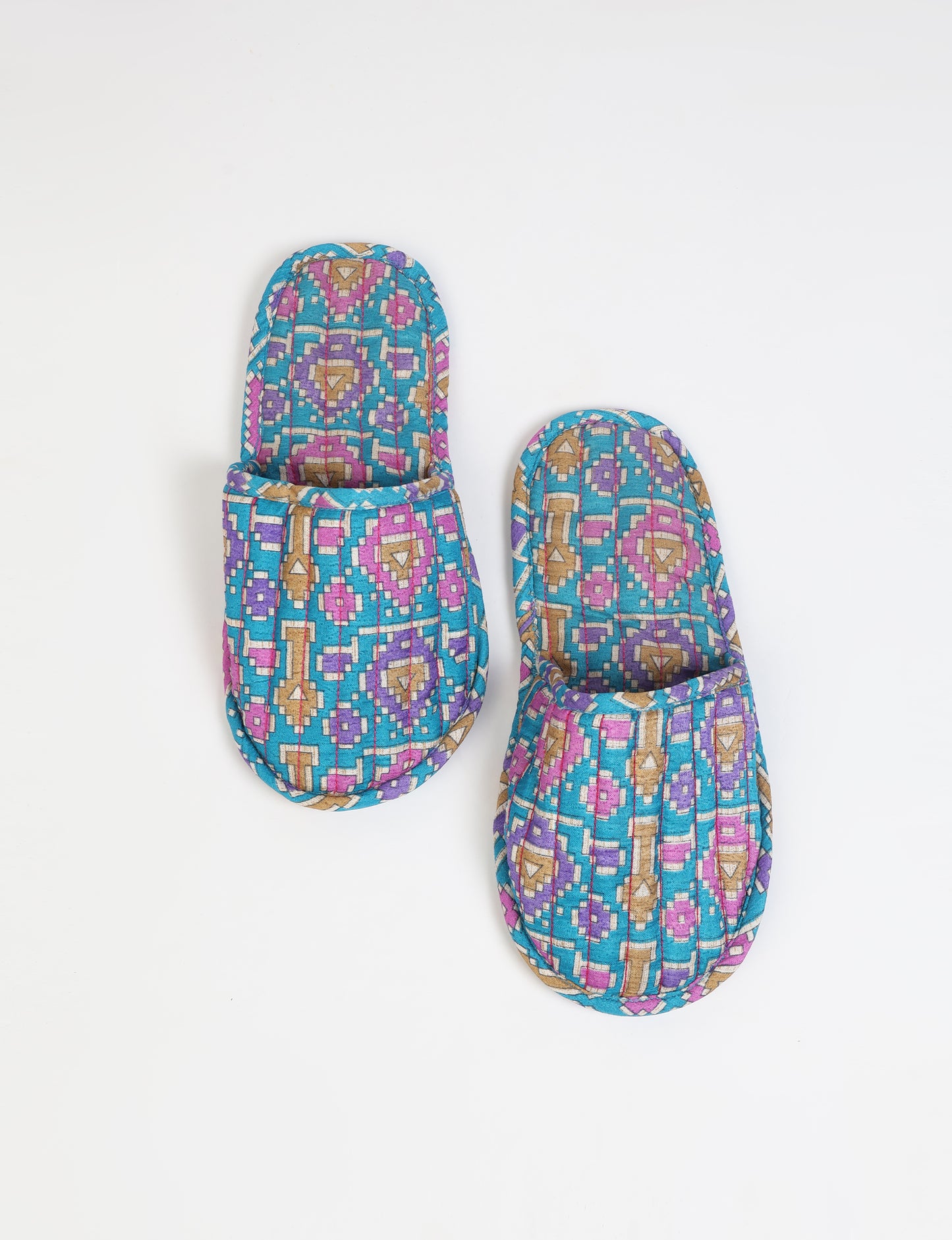 Elevate your downtime with our Quilted Slippers. Ethical, sustainable, and crafted by female artisans in Mumbai, these slippers offer cushioned comfort with a touch of chic style. Warm on the inside, fashionable on the outside, step into sustainable luxury.