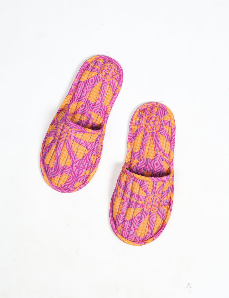 Quilted slippers in pink and orange floral pattern, top view, flat on white background
