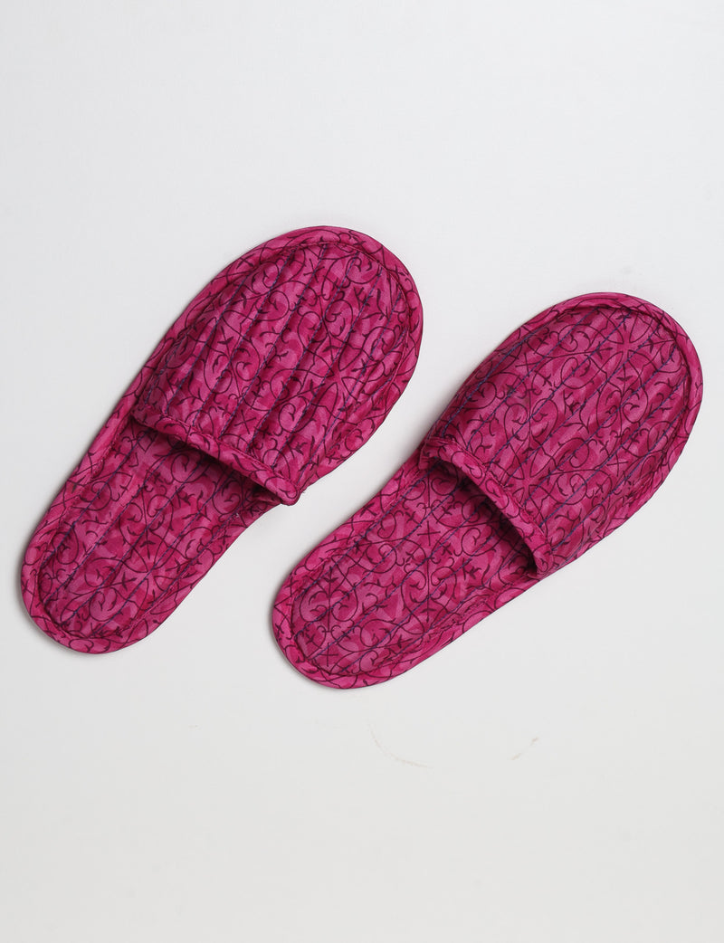 Blue quilted slippers with paisley pattern, open back, and cushioned footbed, shown flat on white background