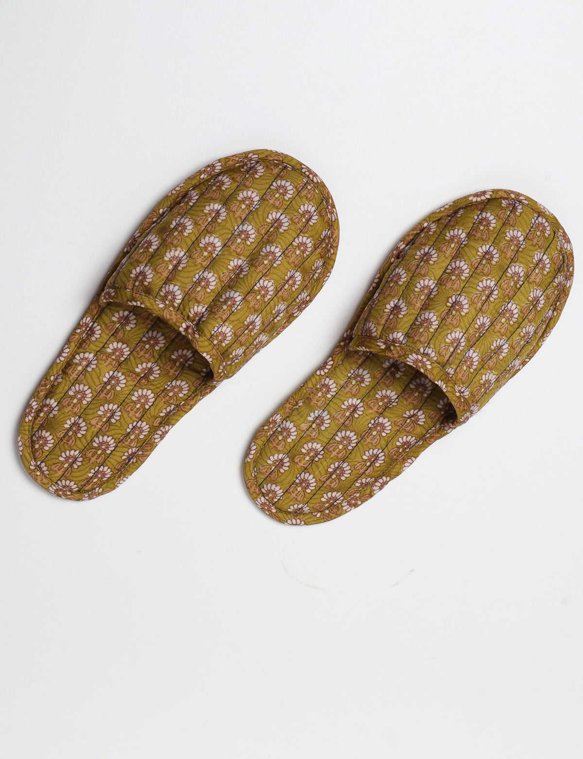 Blue quilted slippers with paisley pattern, open back, and cushioned footbed, shown flat on white background