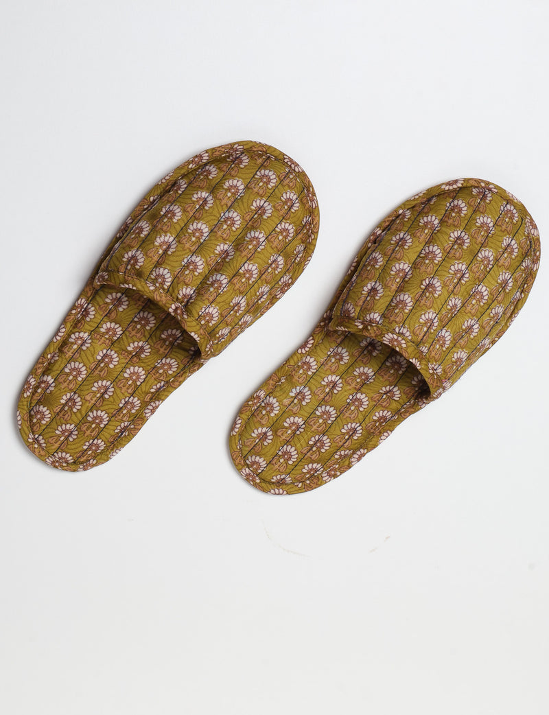 Blue quilted slippers with paisley pattern, open back, and cushioned footbed, shown flat on white background