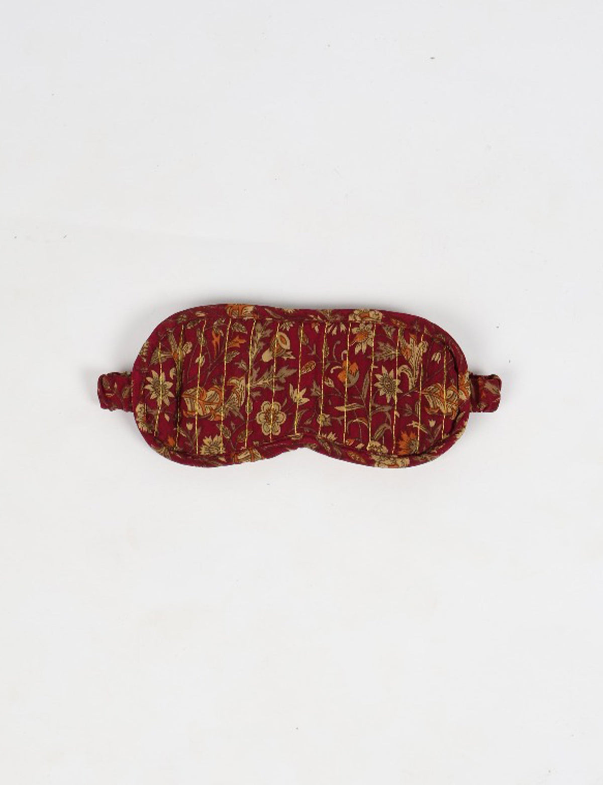 Colorful quilted eye mask made from repurposed fabric, reflecting eco friendly fashion, zero waste clothing, and carbon neutral clothing values.