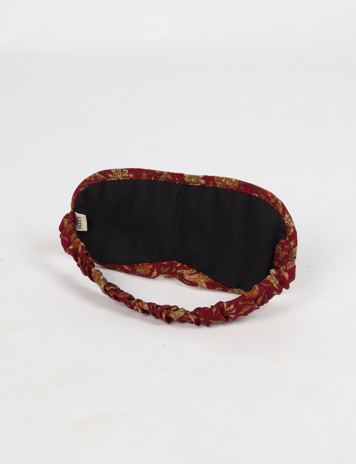 Colorful quilted eye mask made from repurposed fabric, reflecting eco friendly fashion, zero waste clothing, and carbon neutral clothing values.