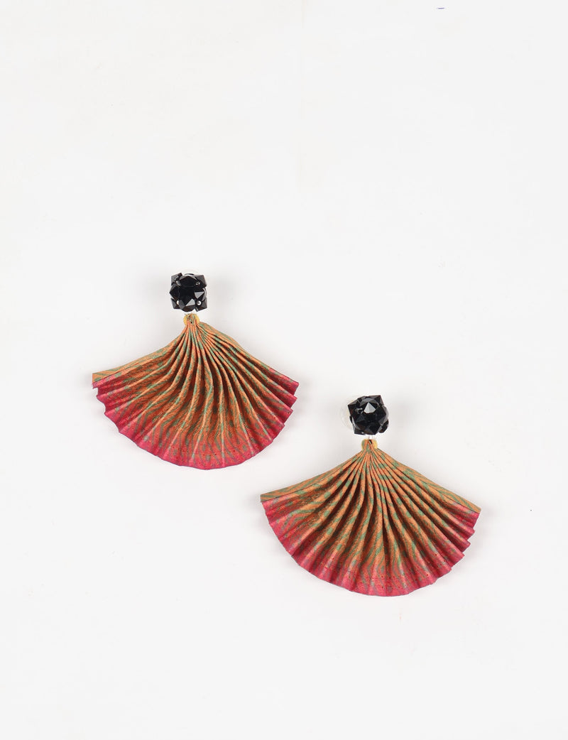 Pair of pleated earrings with pink and green abstract fabric fans and black faceted stud tops, flat lay on white background