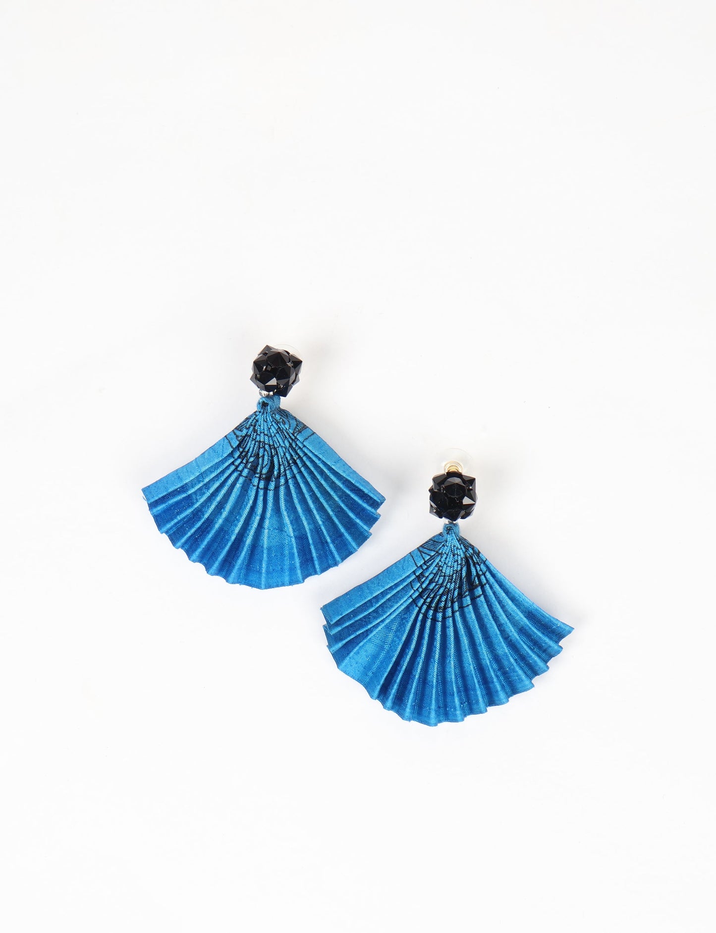 Elevate your style sustainably with our PLEATED EARRINGS – a harmonious blend of ethical fashion and eco-conscious design. Fashioned using innovative heat setting techniques on pre-loved Indian saris, these accessories showcase a commitment to slow fashion and upcycled fashion. Enjoy planet-friendly charm with hypoallergy tested metal hooks, nickel, and lead-free for a skin-friendly touch.