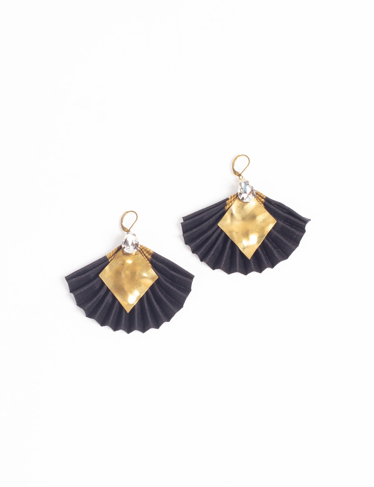 Black pleated fabric earrings with gold diamond-shaped metal accents and clear teardrop crystals, shown flat on white background