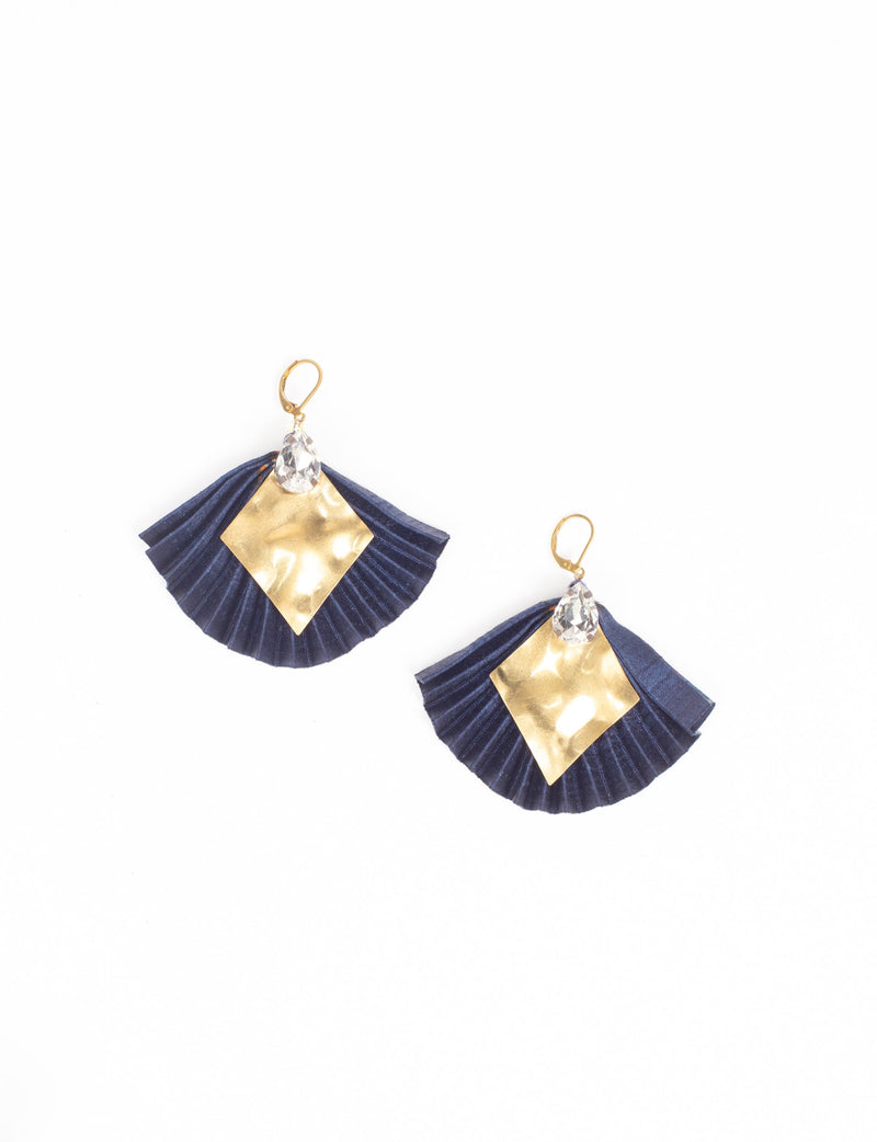 Blue pleated earrings with gold diamond-shaped metal and clear teardrop crystals, shown flat on white background