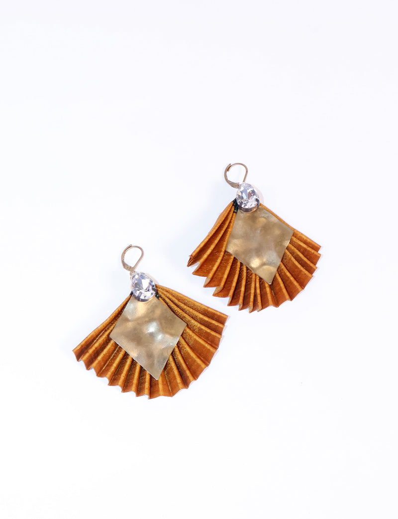 Yellow pleated fabric earrings with hammered gold-tone metal square and clear teardrop gem at top, shown flat on white background