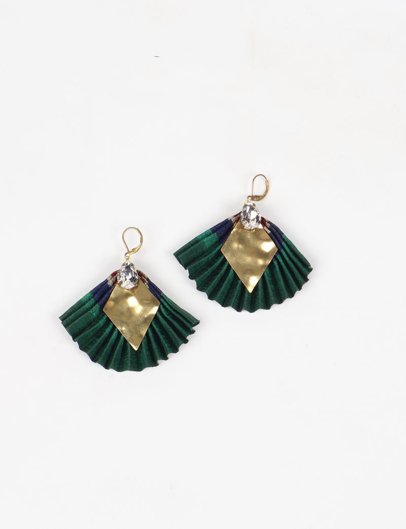Pair of pleated earrings with green and navy fabric, gold diamond-shaped metal, and clear teardrop crystals, flat lay view