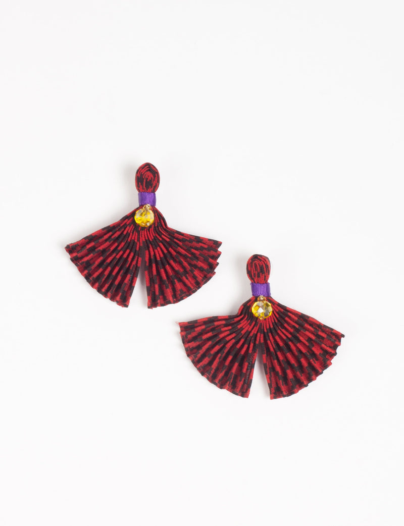 Red and black pleated fabric earrings with purple band and yellow gem detail, shown flat on white background