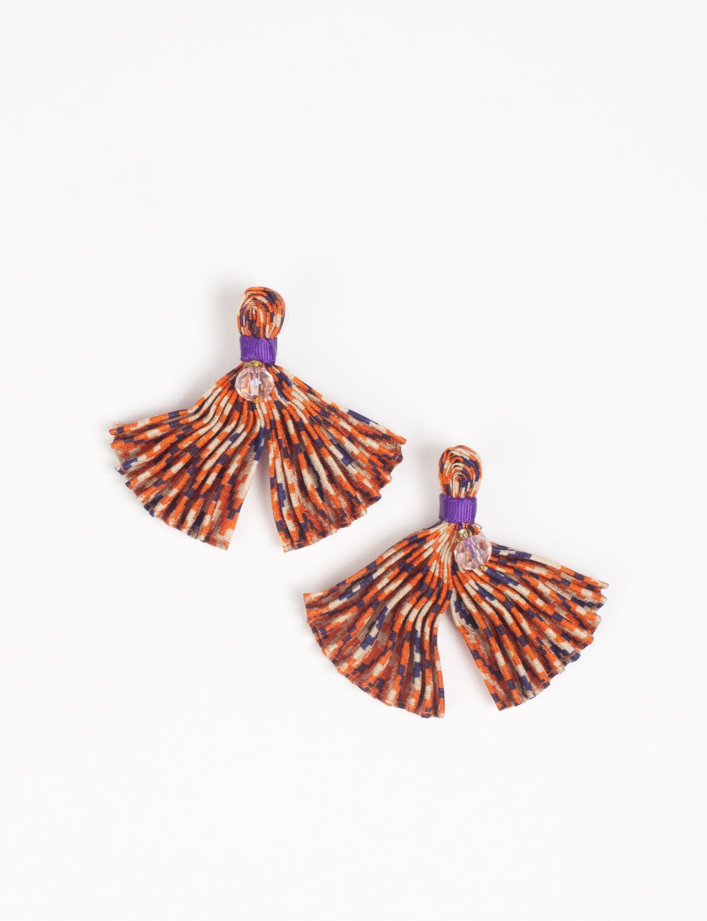 Adorn yourself sustainably with our PLEATED EARRINGS – fan-shaped wonders with a top knot and a tiny stone. Meticulously hand-pleated from Indian saris, these earrings reflect ethical clothing, green fashion, and slow fashion. Fastened with hypoallergy tested metal hooks, nickel, and lead-free, making them a conscious and stylish accessory.