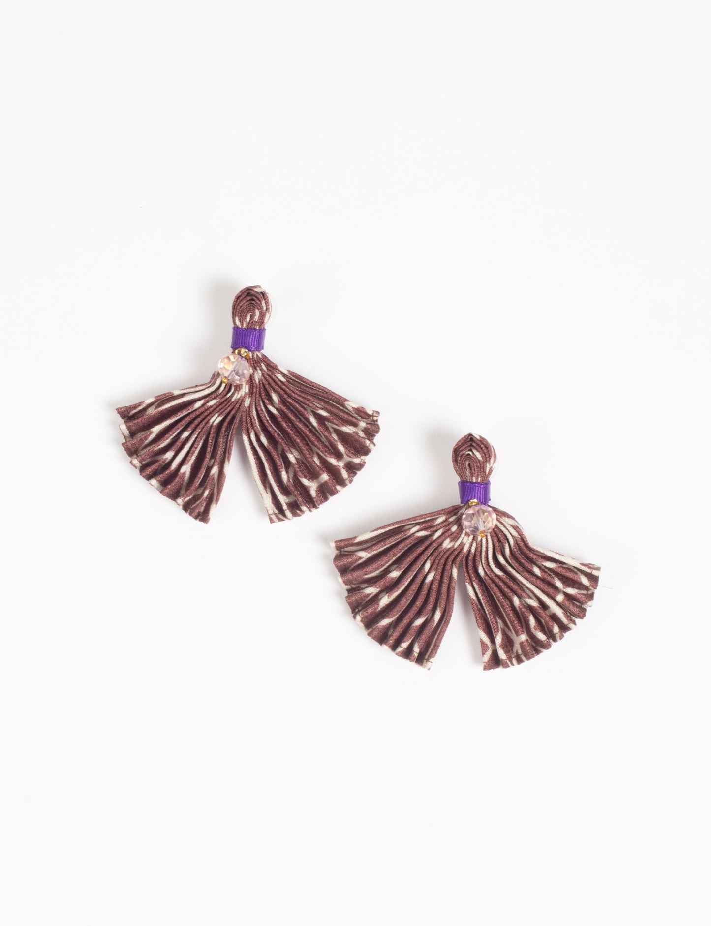 Adorn yourself sustainably with our PLEATED EARRINGS – fan-shaped wonders with a top knot and a tiny stone. Meticulously hand-pleated from Indian saris, these earrings reflect ethical clothing, green fashion, and slow fashion. Fastened with hypoallergy tested metal hooks, nickel, and lead-free, making them a conscious and stylish accessory.