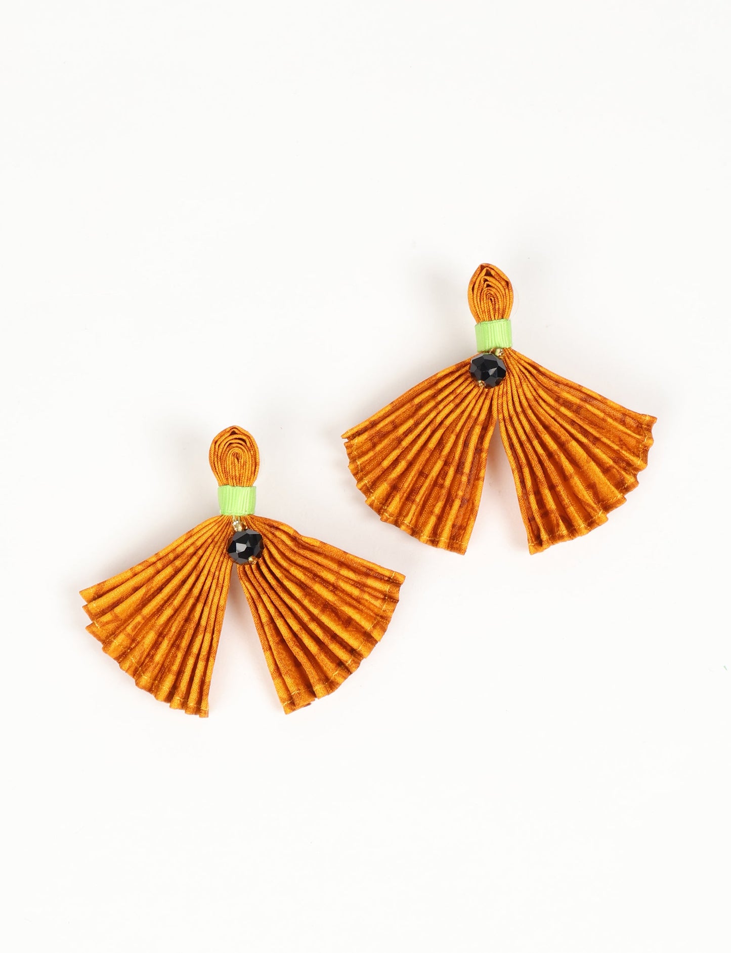 Adorn yourself sustainably with our PLEATED EARRINGS – fan-shaped wonders with a top knot and a tiny stone. Meticulously hand-pleated from Indian saris, these earrings reflect ethical clothing, green fashion, and slow fashion. Fastened with hypoallergy tested metal hooks, nickel, and lead-free, making them a conscious and stylish accessory.