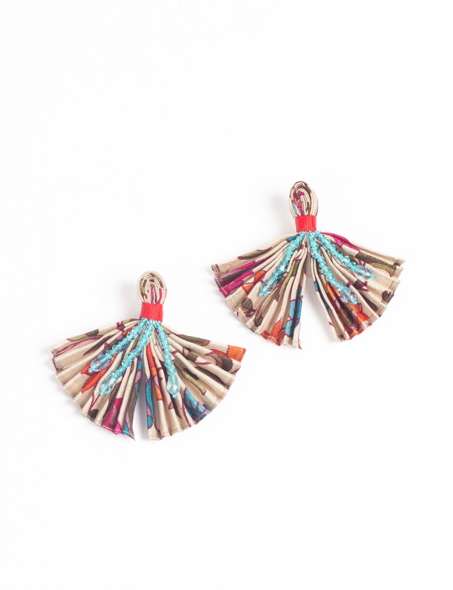 Elevate your look with our PLEATED EARRINGS – embellished with a beaded dangler, diamond-shaped metallic plate, and hook fastening. Crafted with innovative heat setting techniques on pre-loved saris, these earrings showcase ethical clothing, green fashion, and zero waste fashion. Hypoallergy tested metal hooks, nickel, and lead-free for a conscious and stylish accessory.