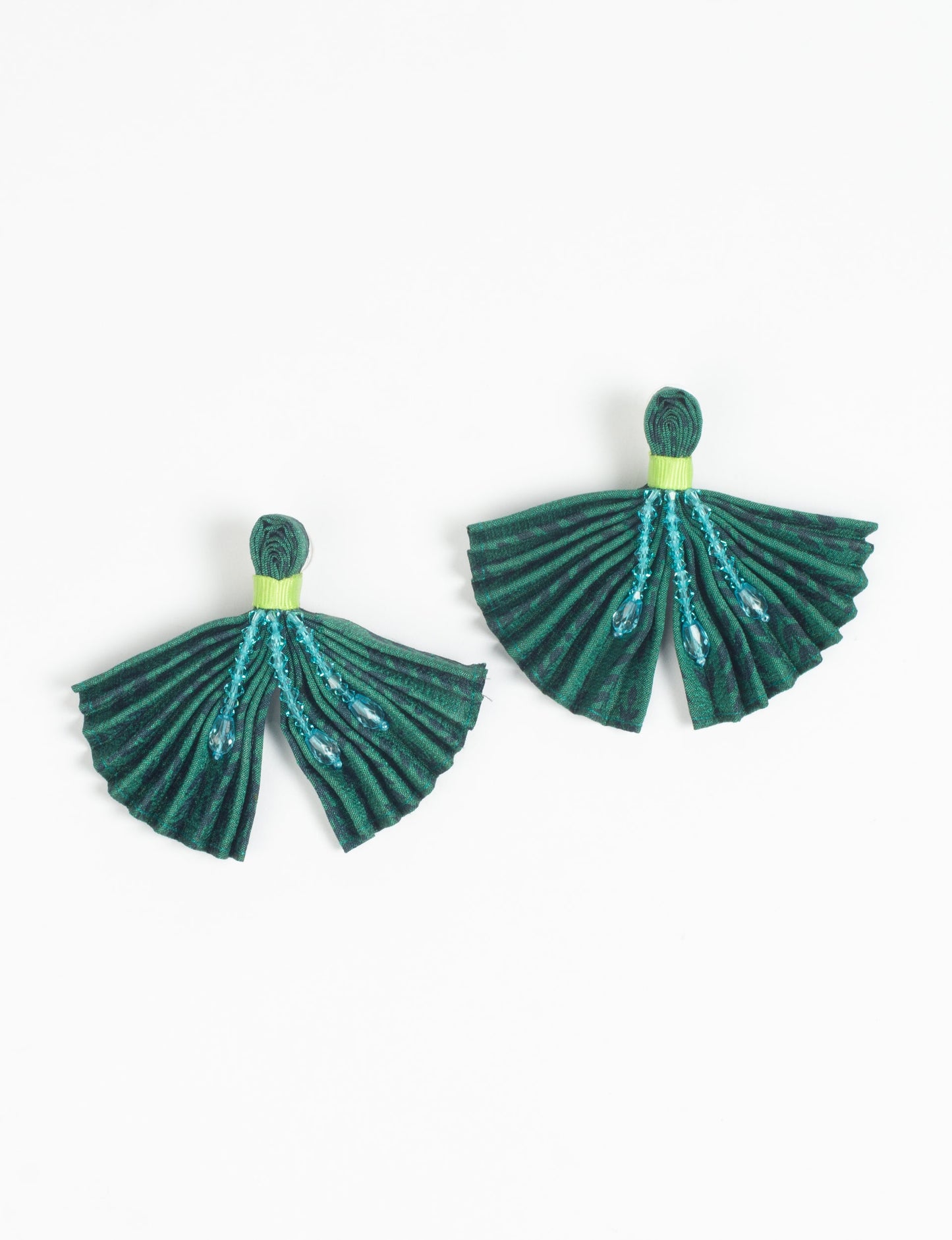 Elevate your look with our PLEATED EARRINGS – embellished with a beaded dangler, diamond-shaped metallic plate, and hook fastening. Crafted with innovative heat setting techniques on pre-loved saris, these earrings showcase ethical clothing, green fashion, and zero waste fashion. Hypoallergy tested metal hooks, nickel, and lead-free for a conscious and stylish accessory.