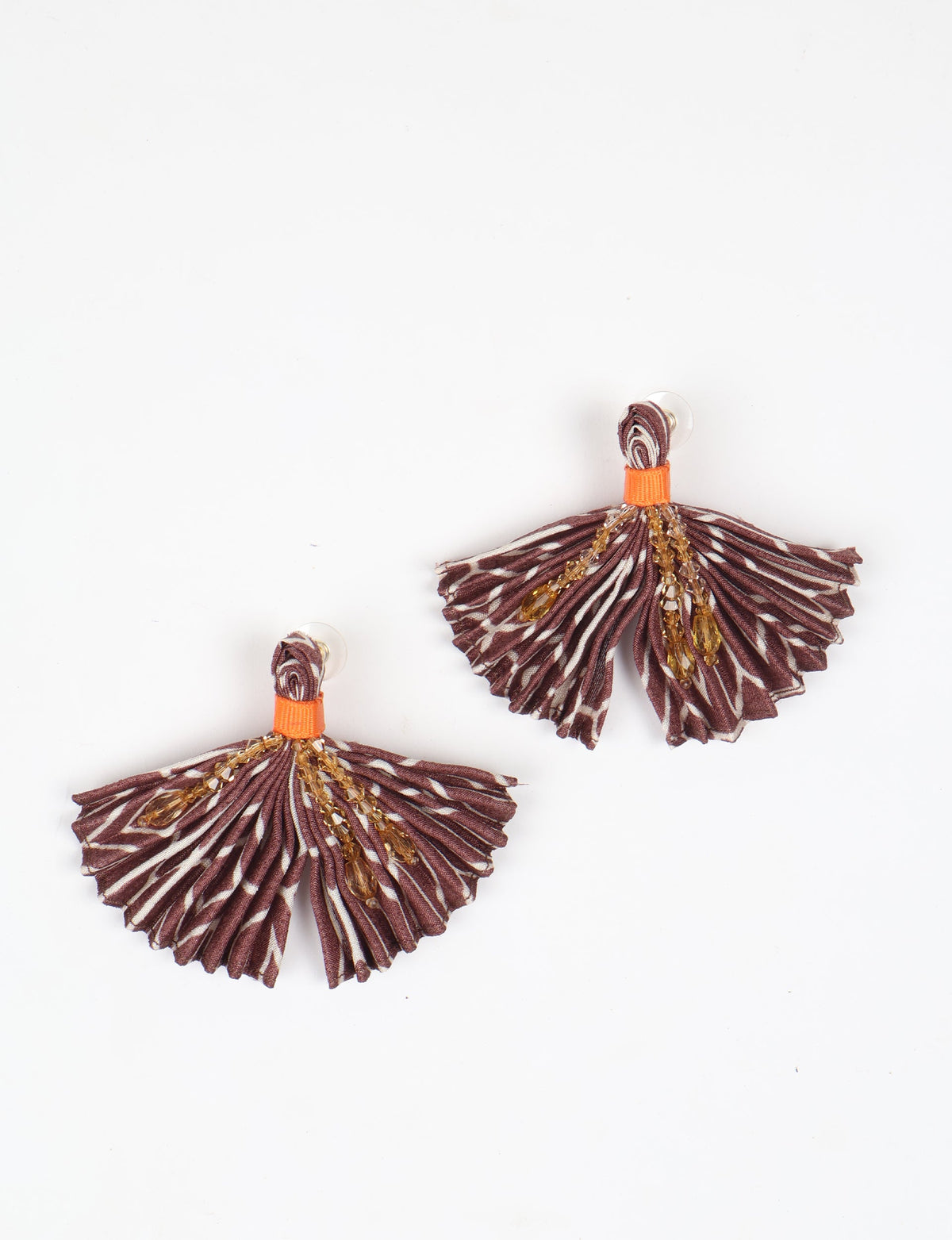 Brown pleated fabric earrings with abstract pattern and amber bead embellishments, shown flat on white background