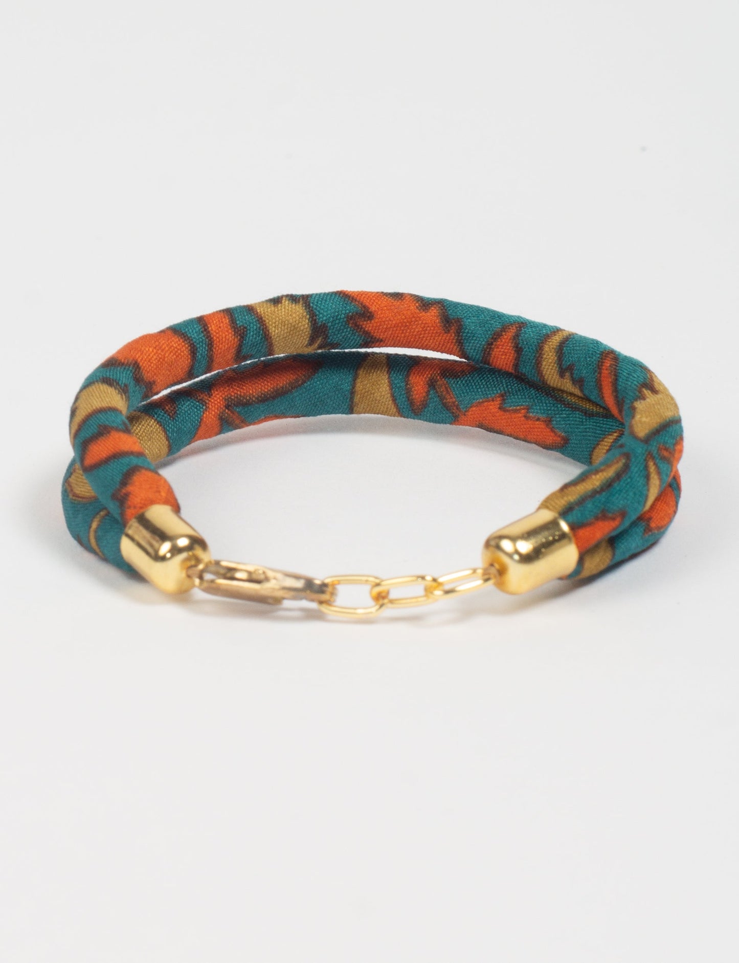 A close-up image of a hand wearing the Sari Rope bracelet, showcasing its colorful threads and unique design. This accessory embodies ethical fashion and sustainability, crafted from repurposed saris for a stylish and eco-conscious statement.