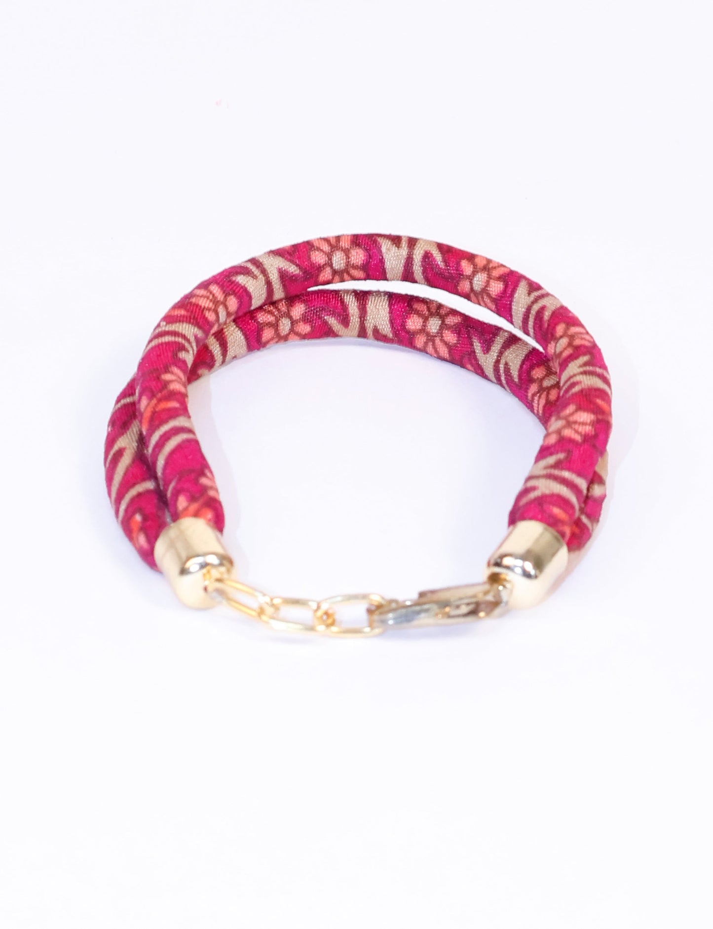 A close-up image of a hand wearing the Sari Rope bracelet, showcasing its colorful threads and unique design. This accessory embodies ethical fashion and sustainability, crafted from repurposed saris for a stylish and eco-conscious statement.