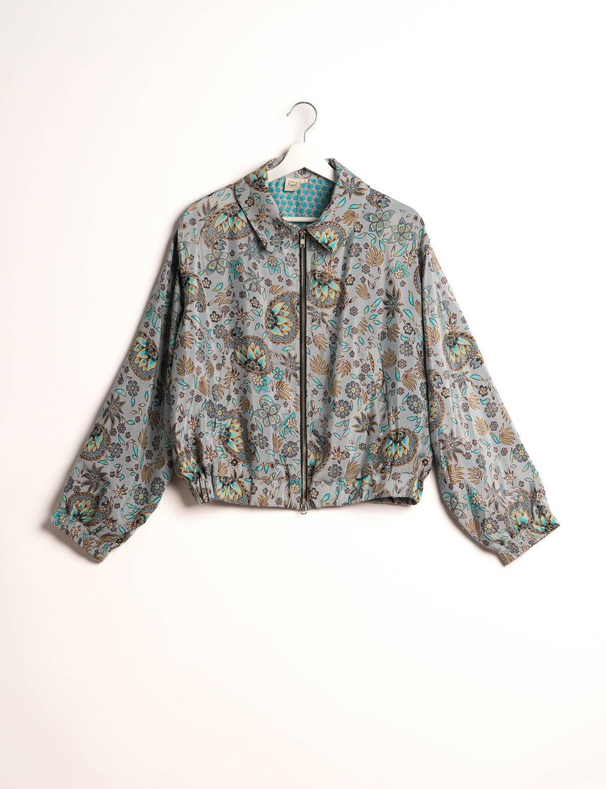 Stylish BOMBER JACKET, an upcycled clothing masterpiece with a cute cropped shape, elasticated details, and detachable metallic zipper. Contrast sari print lining adds a unique touch. Explore sustainable and eco-friendly fashion.