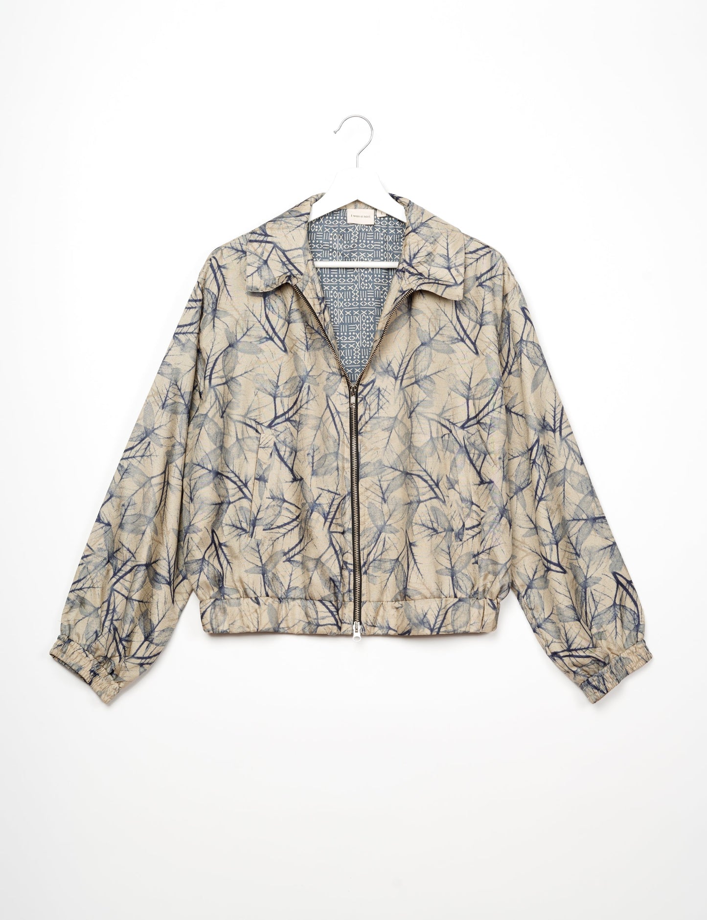 Stylish BOMBER JACKET, an upcycled clothing masterpiece with a cute cropped shape, elasticated details, and detachable metallic zipper. Contrast sari print lining adds a unique touch. Explore sustainable and eco-friendly fashion.