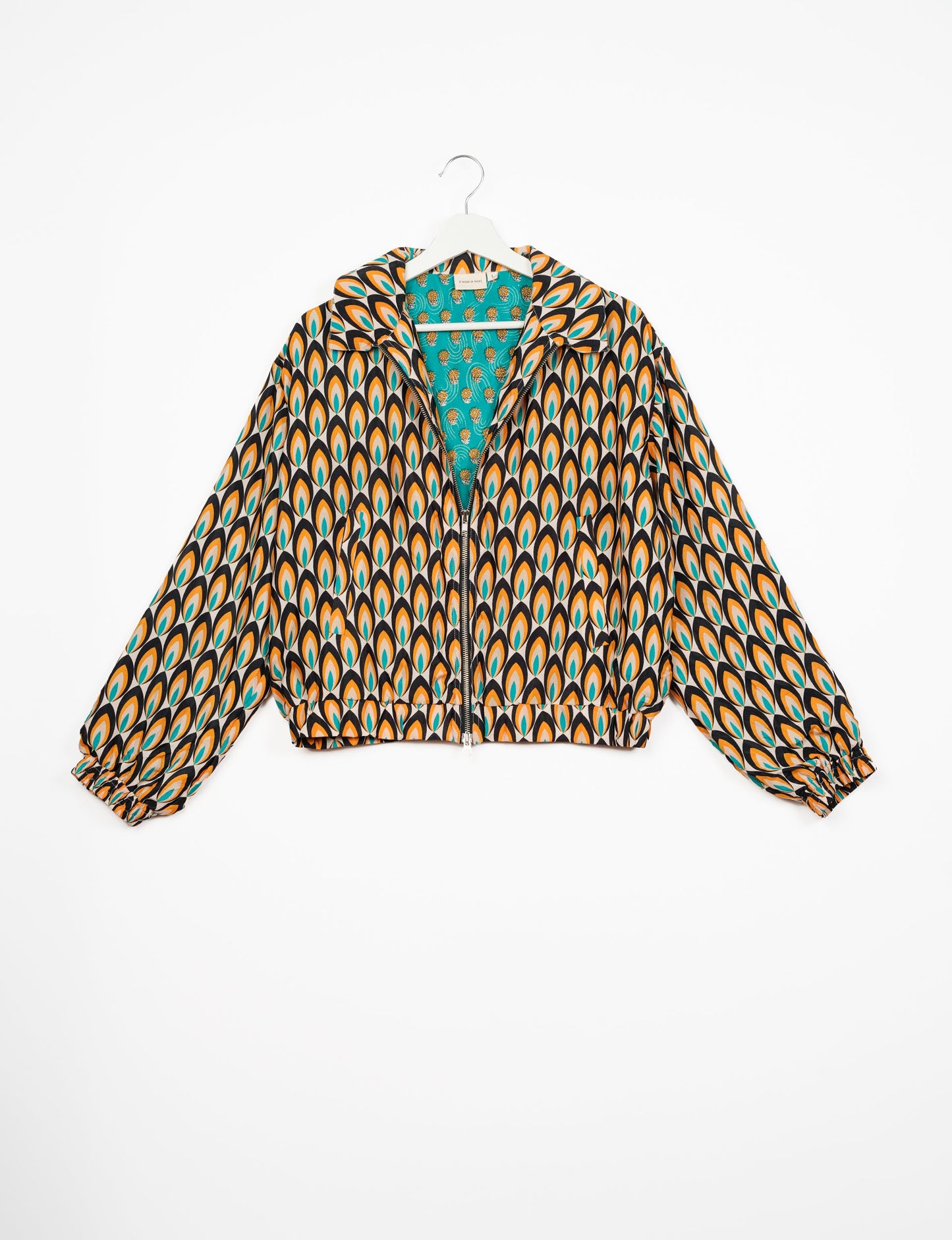 Stylish BOMBER JACKET, an upcycled clothing masterpiece with a cute cropped shape, elasticated details, and detachable metallic zipper. Contrast sari print lining adds a unique touch. Explore sustainable and eco-friendly fashion.