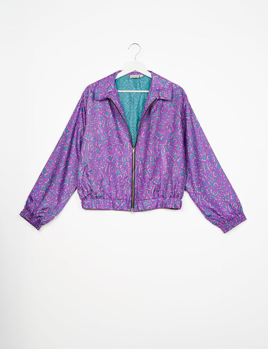 Stylish BOMBER JACKET, an upcycled clothing masterpiece with a cute cropped shape, elasticated details, and detachable metallic zipper. Contrast sari print lining adds a unique touch. Explore sustainable and eco-friendly fashion.