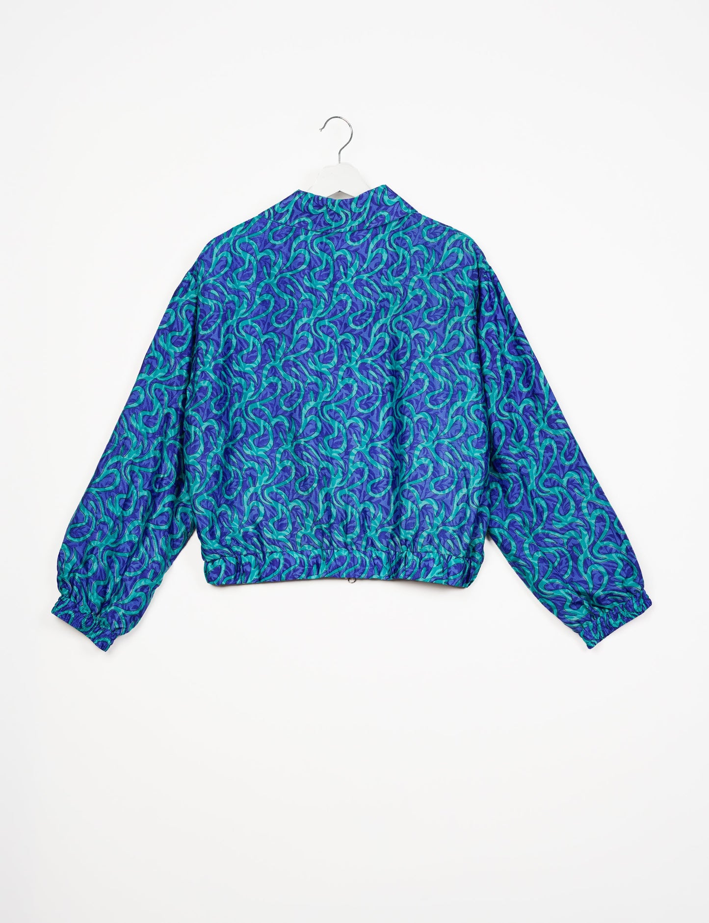 Stylish BOMBER JACKET, an upcycled clothing masterpiece with a cute cropped shape, elasticated details, and detachable metallic zipper. Contrast sari print lining adds a unique touch. Explore sustainable and eco-friendly fashion.