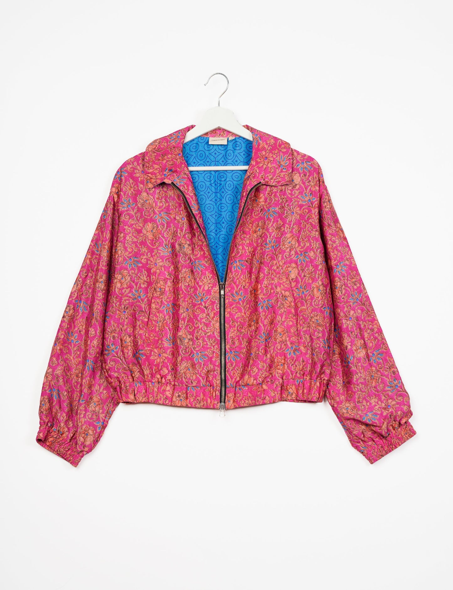 Stylish BOMBER JACKET, an upcycled clothing masterpiece with a cute cropped shape, elasticated details, and detachable metallic zipper. Contrast sari print lining adds a unique touch. Explore sustainable and eco-friendly fashion.