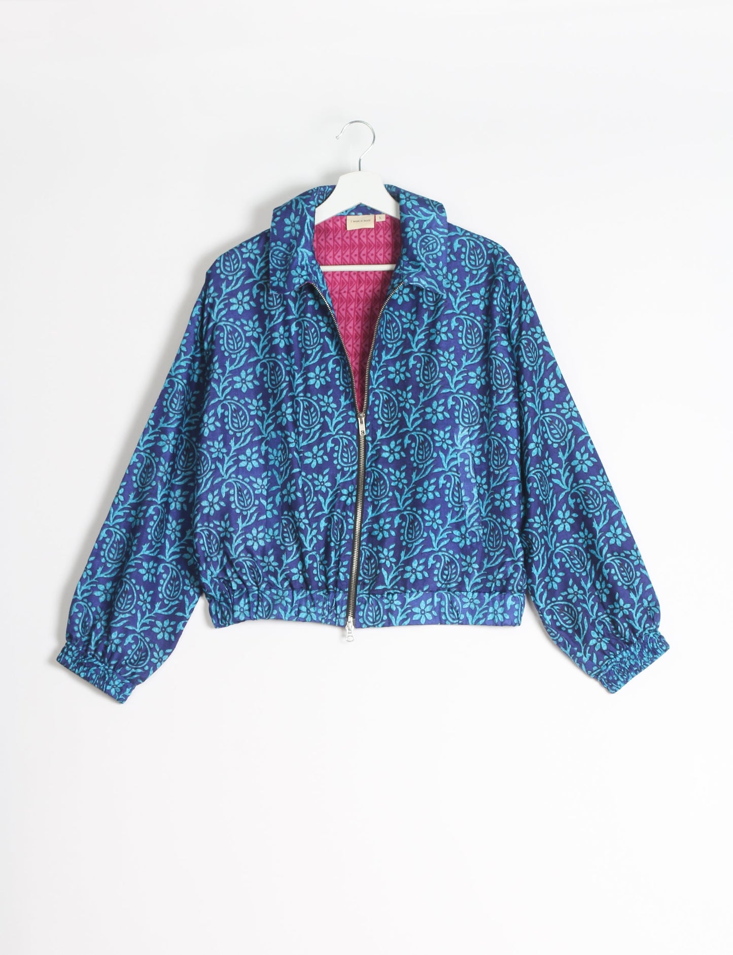 Stylish BOMBER JACKET, an upcycled clothing masterpiece with a cute cropped shape, elasticated details, and detachable metallic zipper. Contrast sari print lining adds a unique touch. Explore sustainable and eco-friendly fashion.