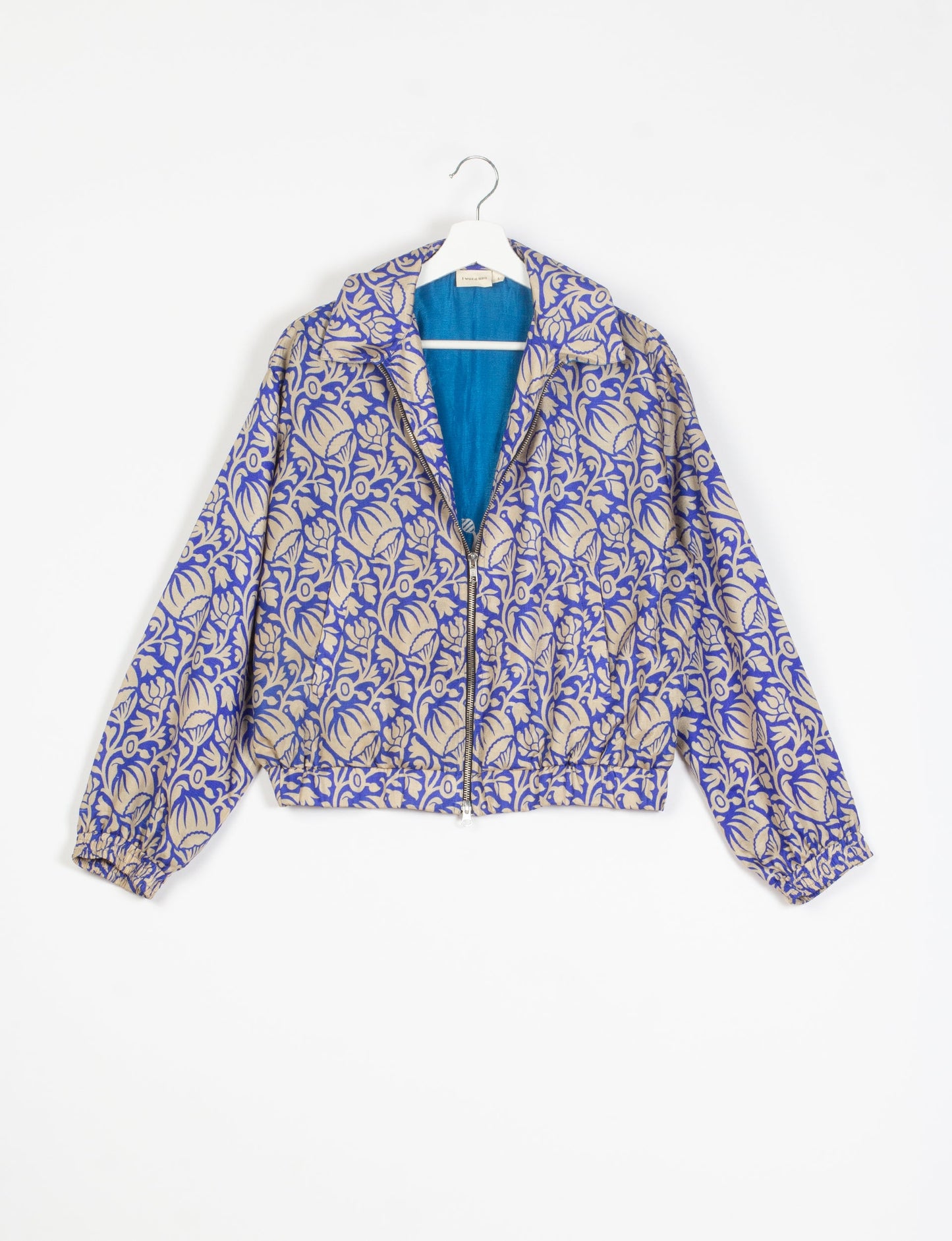 Stylish BOMBER JACKET, an upcycled clothing masterpiece with a cute cropped shape, elasticated details, and detachable metallic zipper. Contrast sari print lining adds a unique touch. Explore sustainable and eco-friendly fashion.