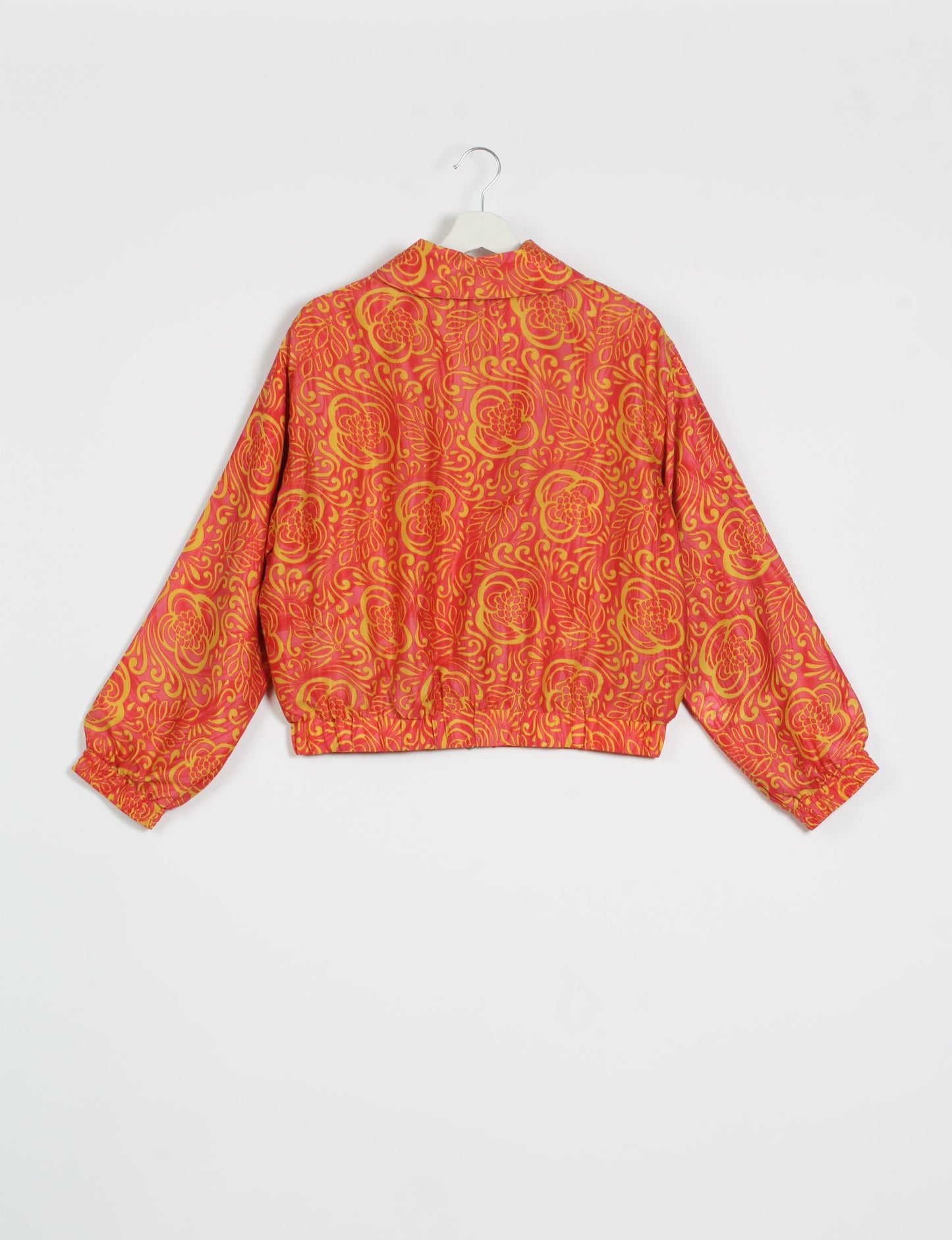 Stylish BOMBER JACKET, an upcycled clothing masterpiece with a cute cropped shape, elasticated details, and detachable metallic zipper. Contrast sari print lining adds a unique touch. Explore sustainable and eco-friendly fashion.