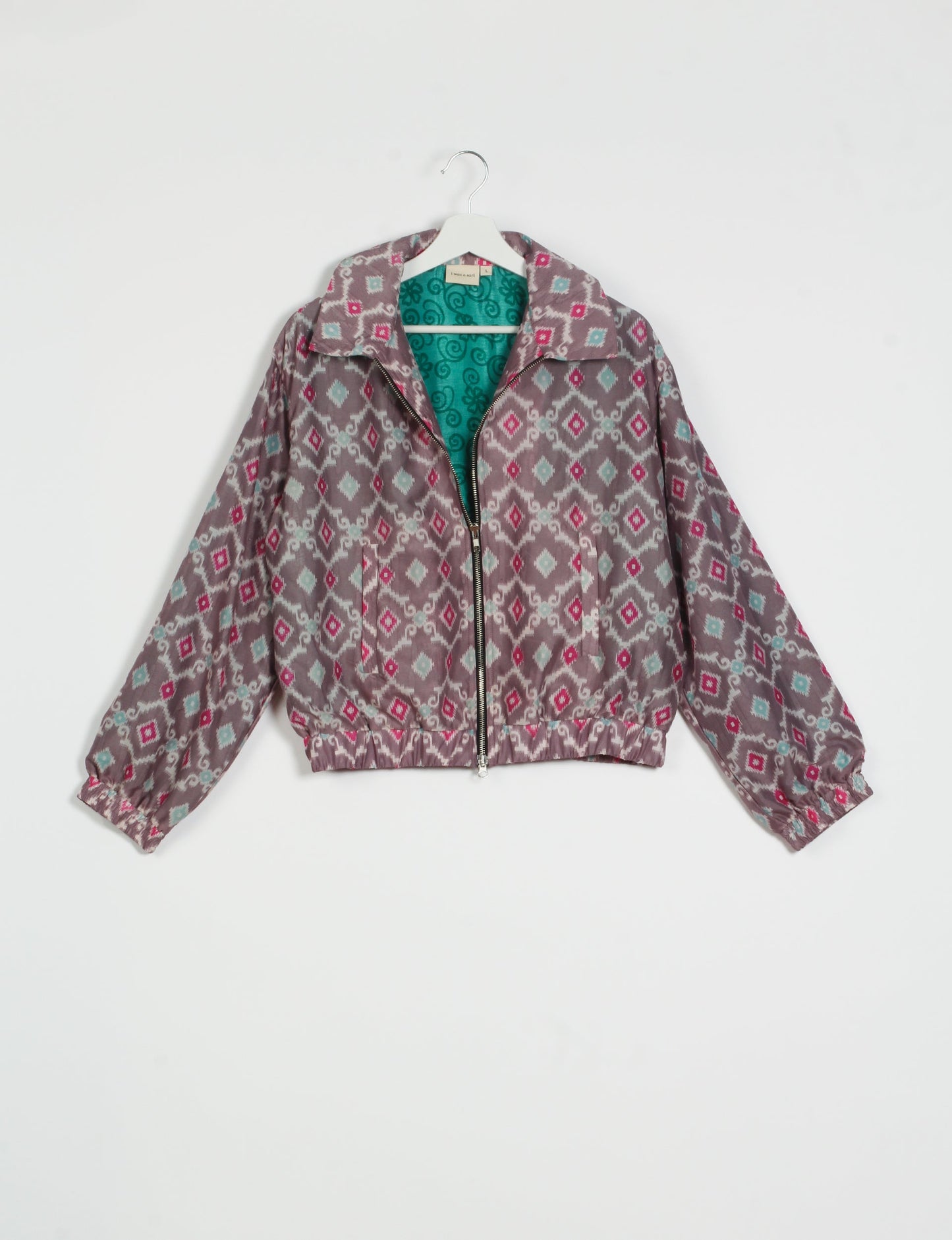 Stylish BOMBER JACKET, an upcycled clothing masterpiece with a cute cropped shape, elasticated details, and detachable metallic zipper. Contrast sari print lining adds a unique touch. Explore sustainable and eco-friendly fashion.