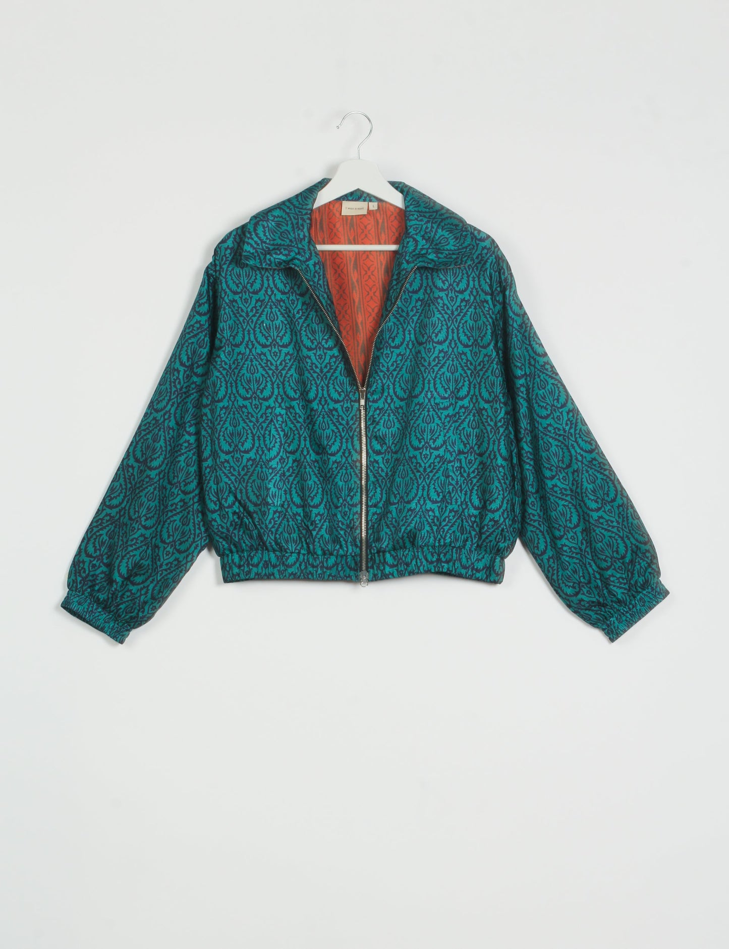 Stylish BOMBER JACKET, an upcycled clothing masterpiece with a cute cropped shape, elasticated details, and detachable metallic zipper. Contrast sari print lining adds a unique touch. Explore sustainable and eco-friendly fashion.