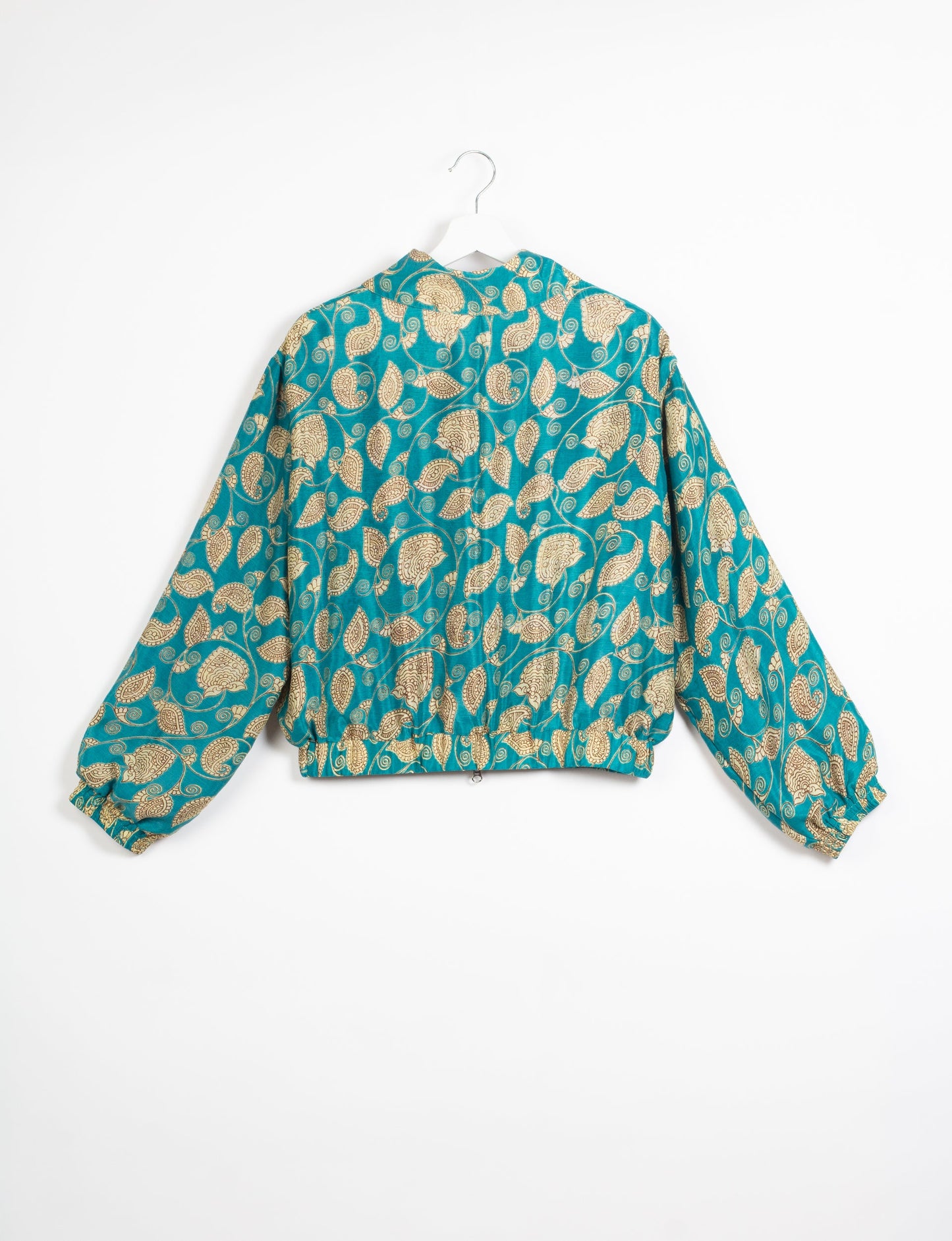 Stylish BOMBER JACKET, an upcycled clothing masterpiece with a cute cropped shape, elasticated details, and detachable metallic zipper. Contrast sari print lining adds a unique touch. Explore sustainable and eco-friendly fashion.