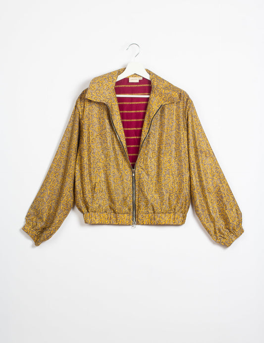 Stylish BOMBER JACKET, an upcycled clothing masterpiece with a cute cropped shape, elasticated details, and detachable metallic zipper. Contrast sari print lining adds a unique touch. Explore sustainable and eco-friendly fashion.