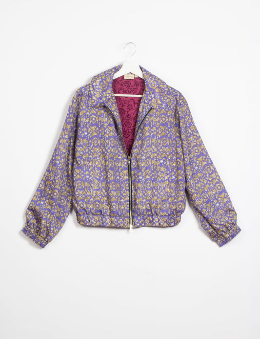 Stylish BOMBER JACKET, an upcycled clothing masterpiece with a cute cropped shape, elasticated details, and detachable metallic zipper. Contrast sari print lining adds a unique touch. Explore sustainable and eco-friendly fashion.