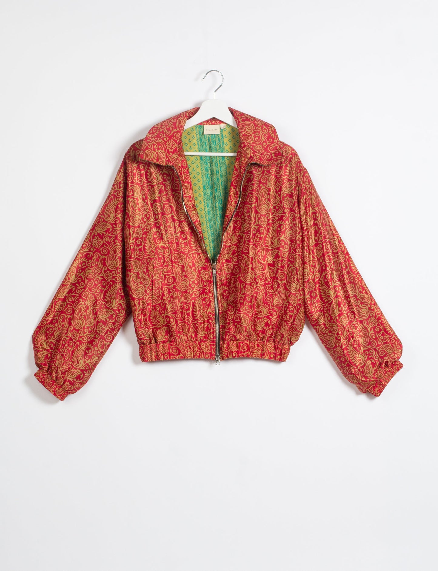 Stylish BOMBER JACKET, an upcycled clothing masterpiece with a cute cropped shape, elasticated details, and detachable metallic zipper. Contrast sari print lining adds a unique touch. Explore sustainable and eco-friendly fashion.