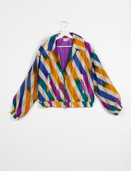 Stylish BOMBER JACKET, an upcycled clothing masterpiece with a cute cropped shape, elasticated details, and detachable metallic zipper. Contrast sari print lining adds a unique touch. Explore sustainable and eco-friendly fashion.