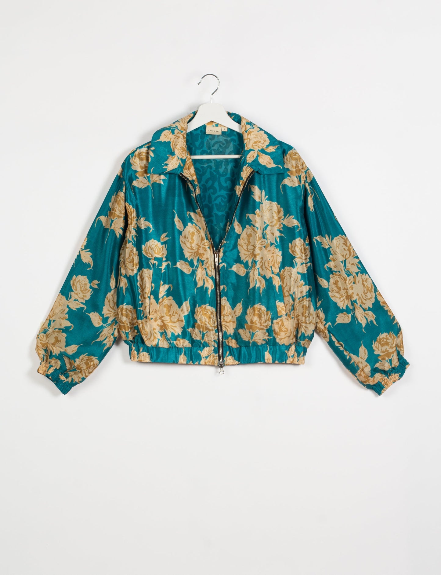 Stylish BOMBER JACKET, an upcycled clothing masterpiece with a cute cropped shape, elasticated details, and detachable metallic zipper. Contrast sari print lining adds a unique touch. Explore sustainable and eco-friendly fashion.