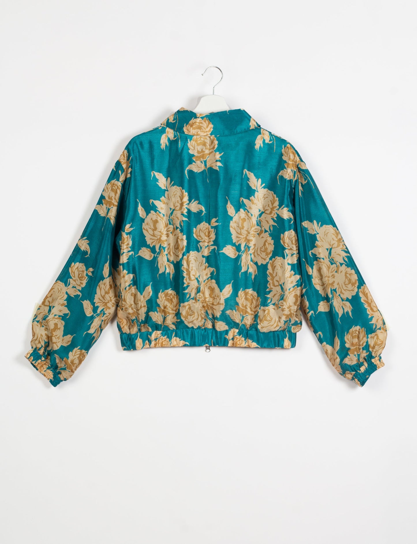 Stylish BOMBER JACKET, an upcycled clothing masterpiece with a cute cropped shape, elasticated details, and detachable metallic zipper. Contrast sari print lining adds a unique touch. Explore sustainable and eco-friendly fashion.