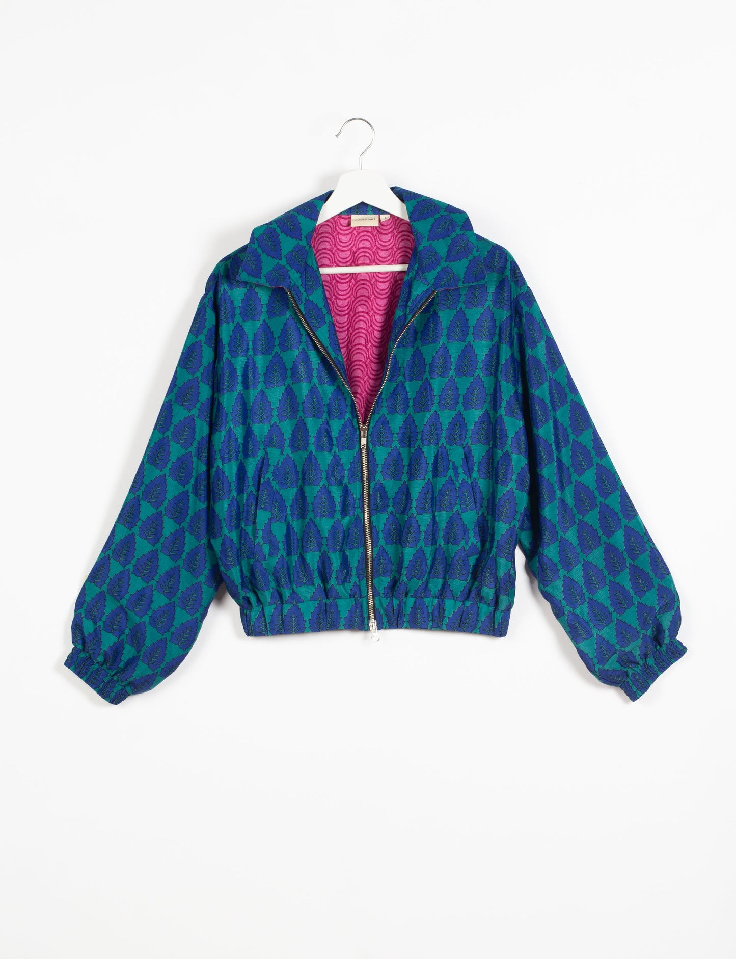 Stylish BOMBER JACKET, an upcycled clothing masterpiece with a cute cropped shape, elasticated details, and detachable metallic zipper. Contrast sari print lining adds a unique touch. Explore sustainable and eco-friendly fashion.