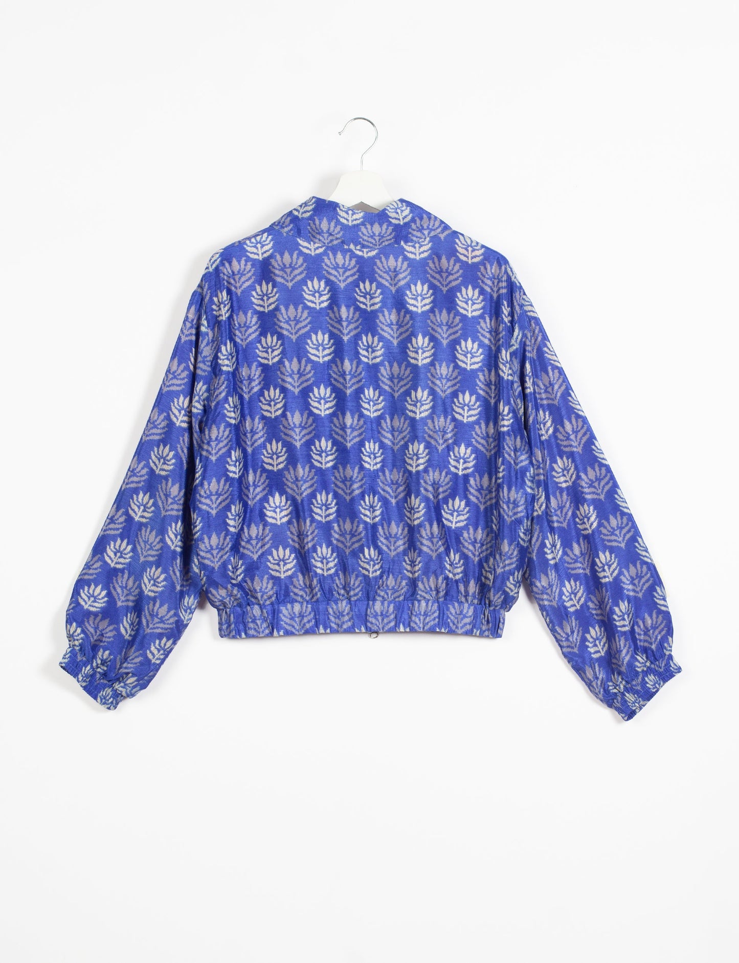 Stylish BOMBER JACKET, an upcycled clothing masterpiece with a cute cropped shape, elasticated details, and detachable metallic zipper. Contrast sari print lining adds a unique touch. Explore sustainable and eco-friendly fashion.