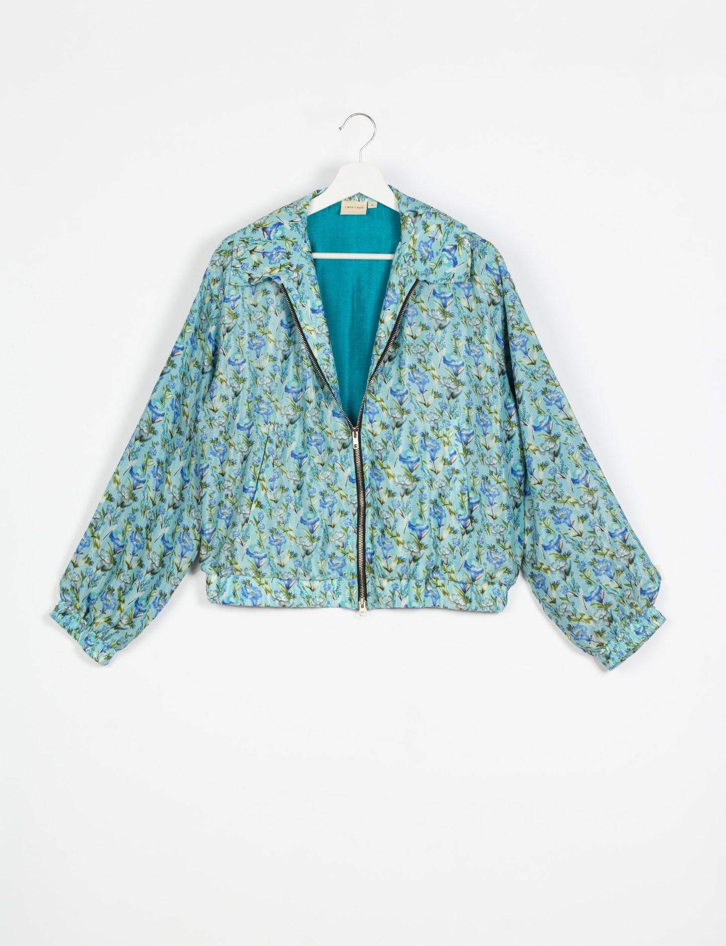 Stylish BOMBER JACKET, an upcycled clothing masterpiece with a cute cropped shape, elasticated details, and detachable metallic zipper. Contrast sari print lining adds a unique touch. Explore sustainable and eco-friendly fashion.