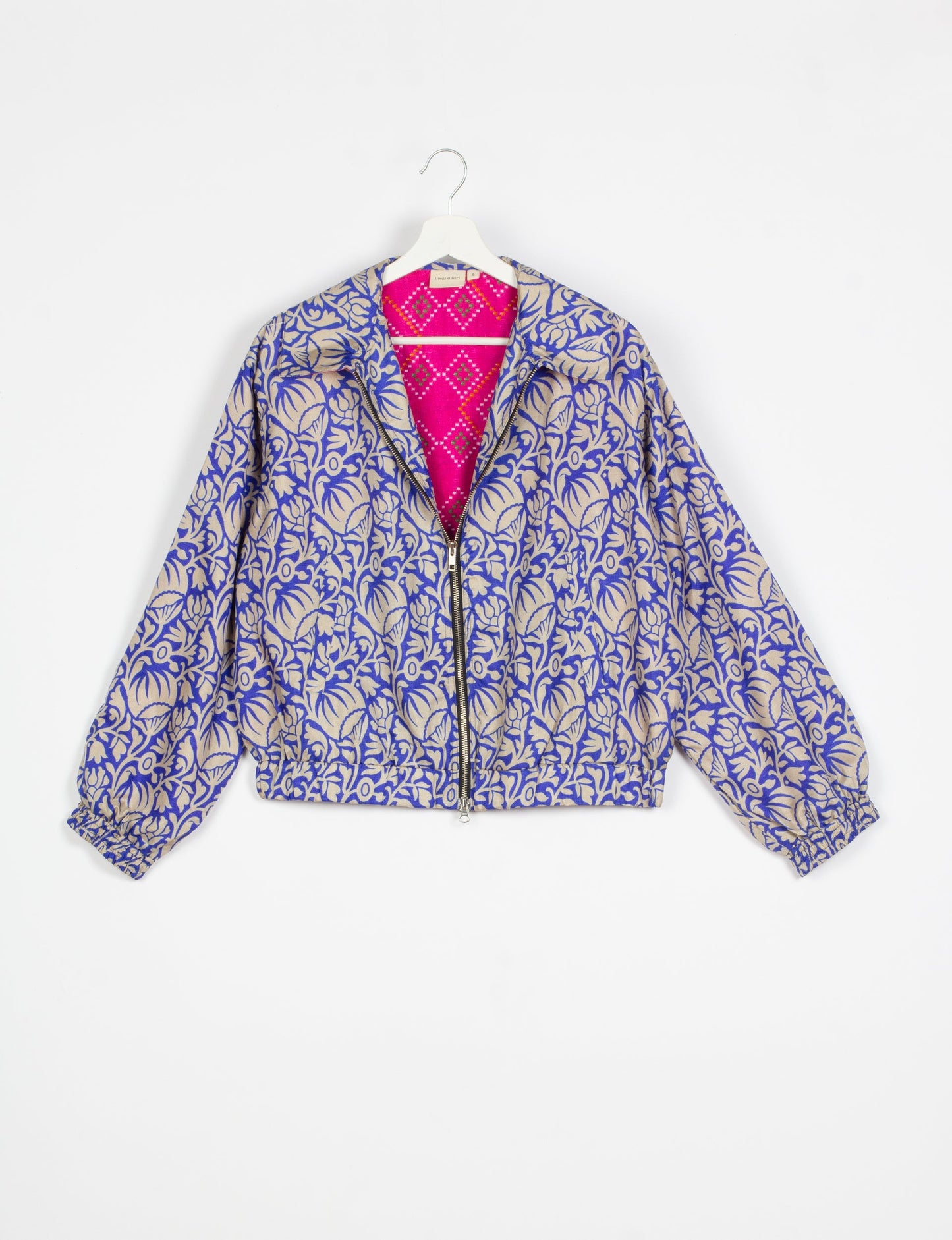 Stylish BOMBER JACKET, an upcycled clothing masterpiece with a cute cropped shape, elasticated details, and detachable metallic zipper. Contrast sari print lining adds a unique touch. Explore sustainable and eco-friendly fashion.